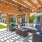 pergola covered patio with a couch and a table and chairs