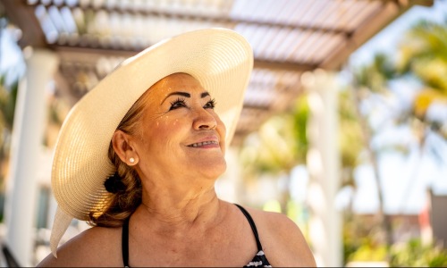 a woman smiling with a hat