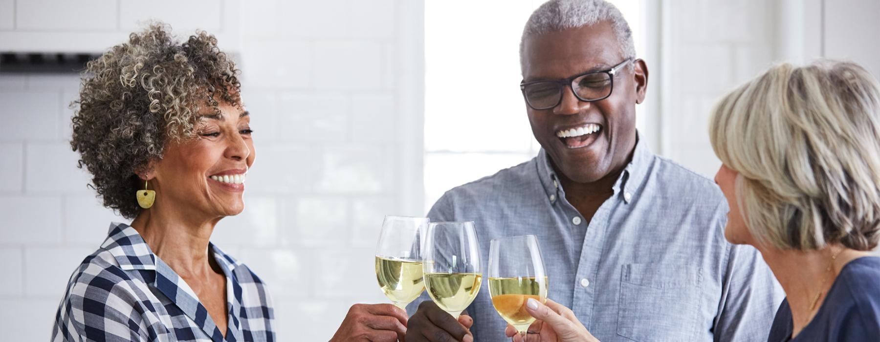 a few people toasting wine glasses